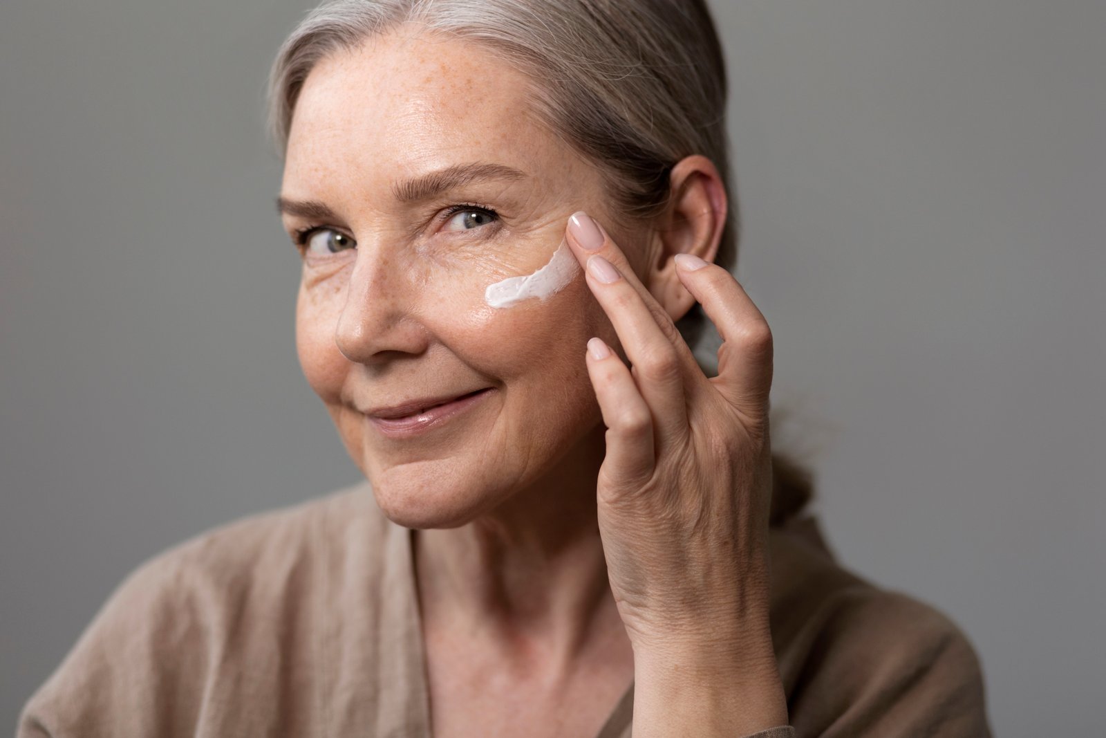 Woman applying eye cream