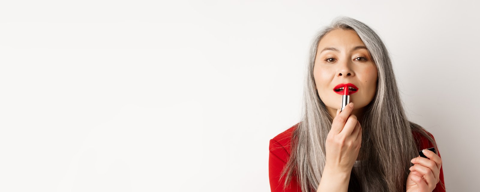 Woman applying lipstick
