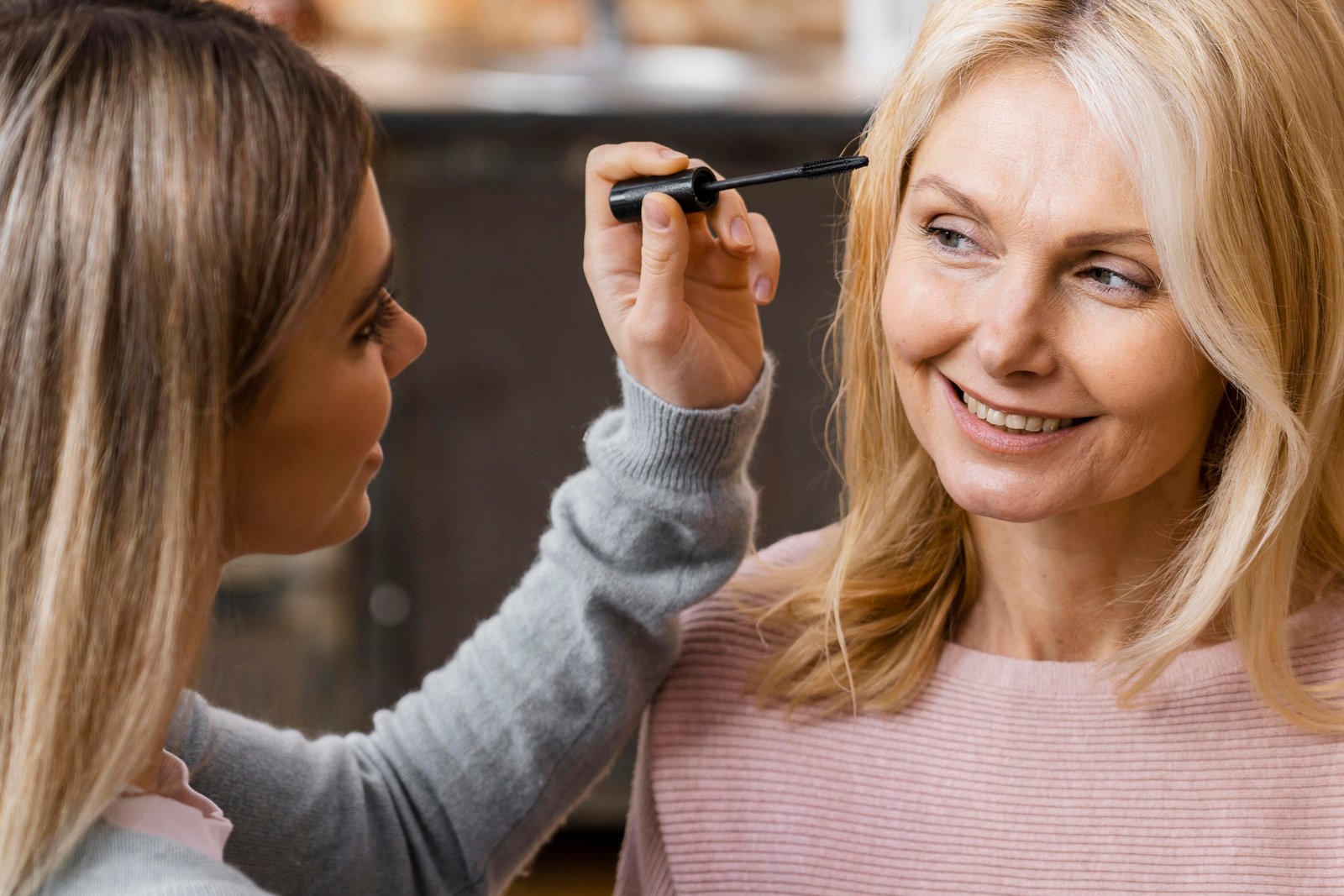 Woman applying mascara