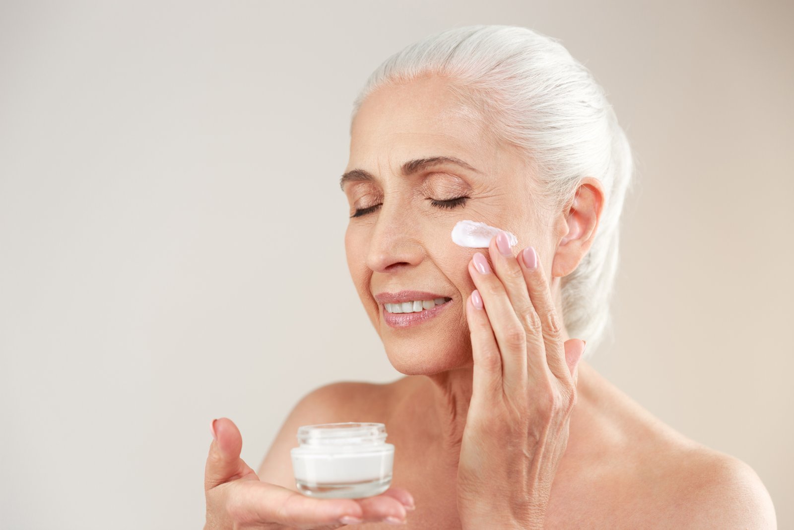Woman applying a luxury anti-aging face cream