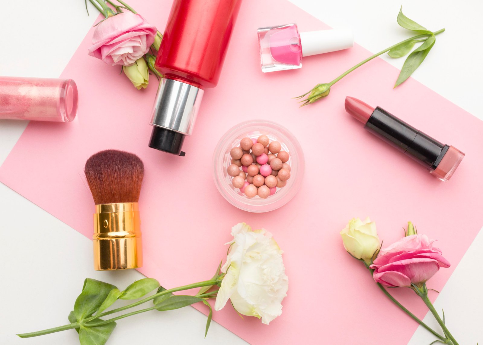 Makeup products and brushes arranged on a vanity